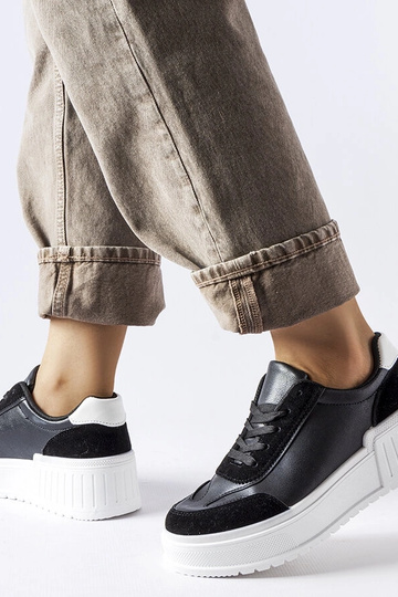 Schwarze Sneaker auf dickem...