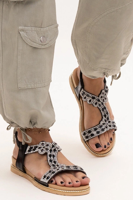 Shahidas glänzende schwarze Sandalen