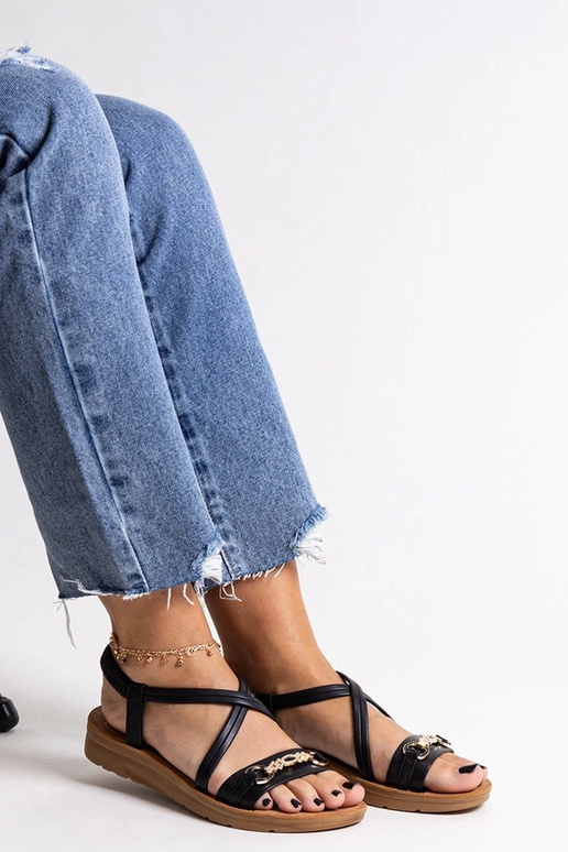 Schwarze Sandalen mit goldener... Schwarze Sandalen mit goldener...