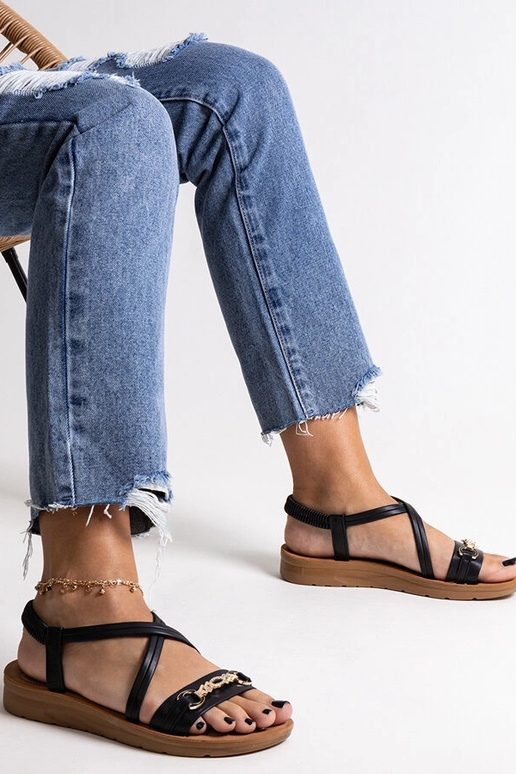 Schwarze Sandalen mit goldener... Schwarze Sandalen mit goldener...